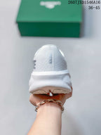 Rear view of the white sneaker showing the padded heel and textured upper.
