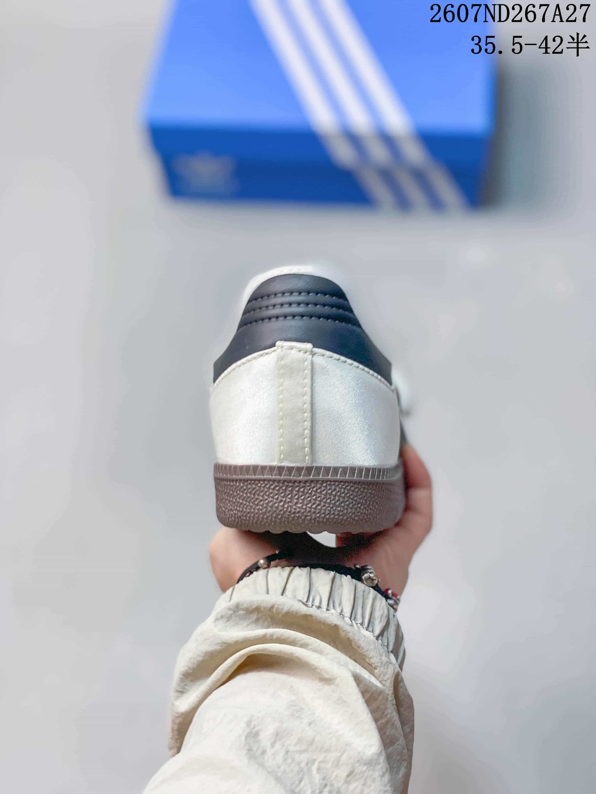 Rear view of the white sneaker showing the dark padded heel panel and textured outsole.