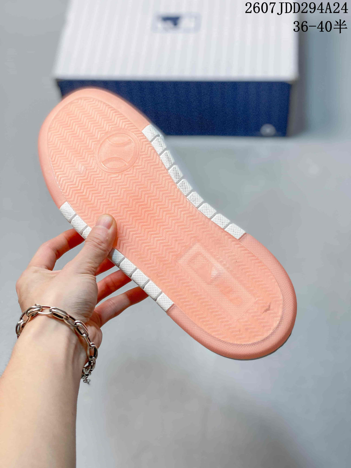 Close view of the pink rubber outsole with a repeating herringbone tread pattern.