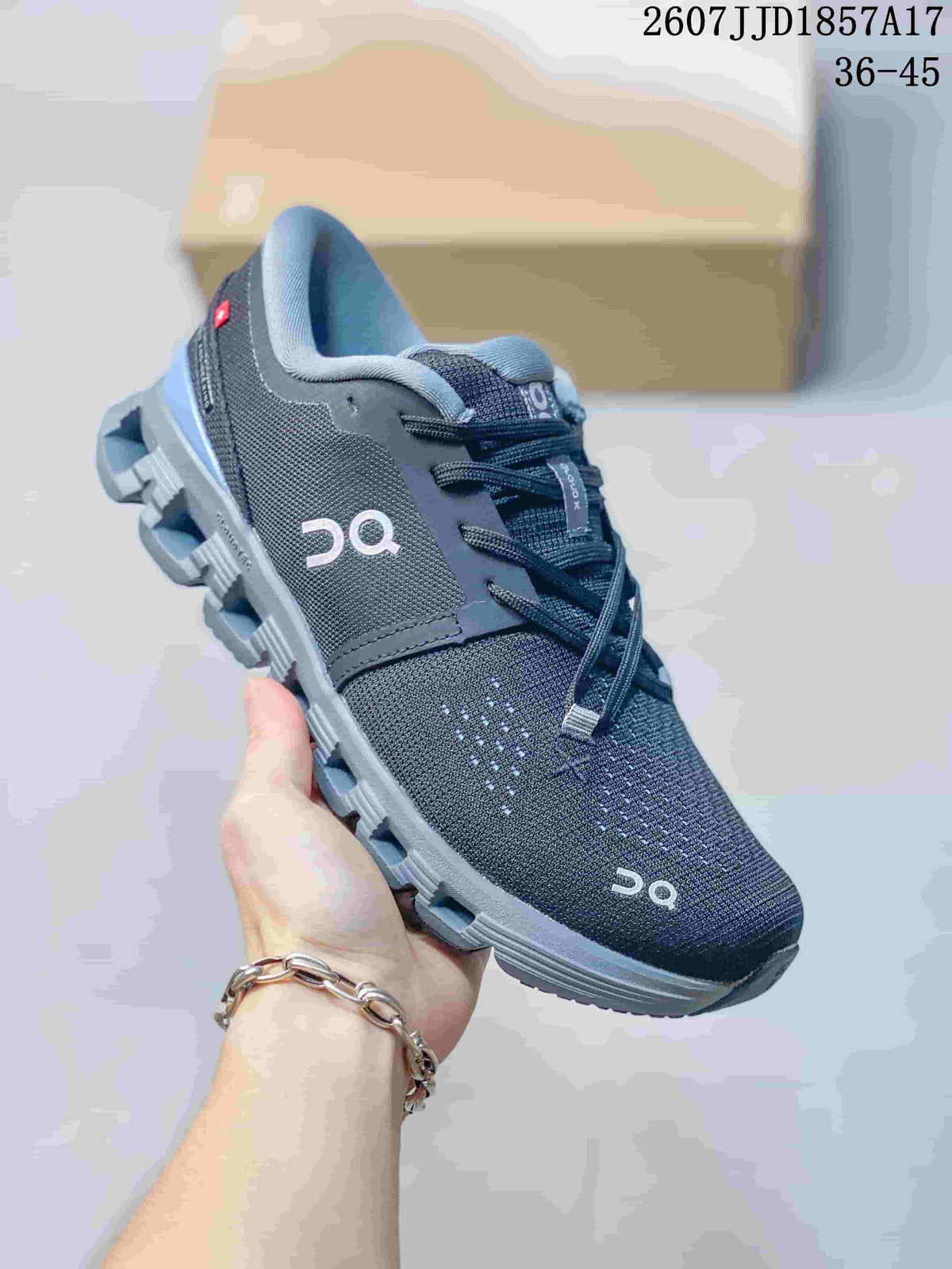 Close-up side view of a black and gray On Cloud X 4 sneaker.