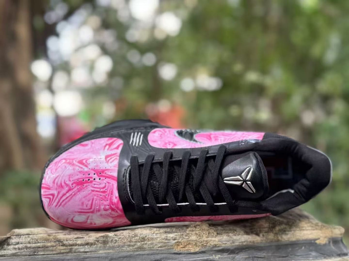 Top view showing black laces and metallic tongue emblem