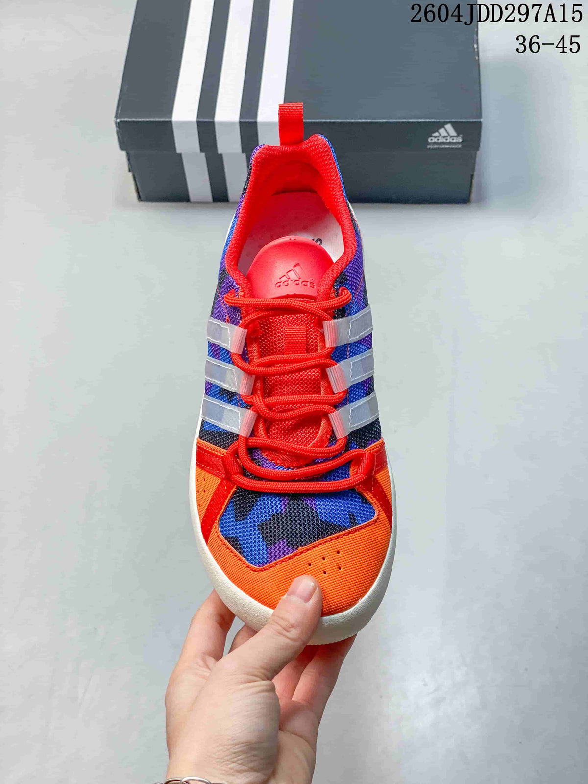 Top view showing the orange toe, blue and purple patterned upper, red laces and translucent side overlays.