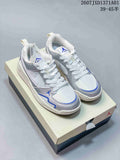 Pair of white and silver Jordan CMFT Era low-top sneakers with blue accents, displayed on a shoebox.