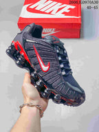 Black Nike Shox TL sneaker with red accents and sculpted segmented sole
