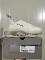White Balenciaga Triple S sneaker displayed on its box; the box label shows Triple S Clear Sole, style code 0315, and size E 40.