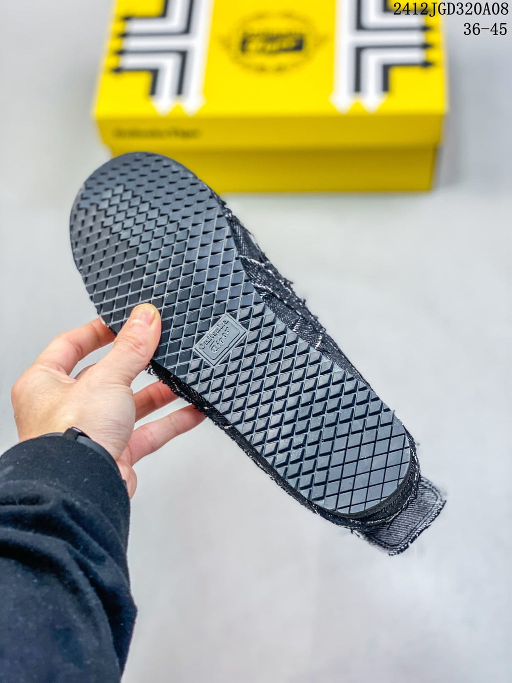Underside view showing the sneakers' black diamond-pattern rubber outsole.