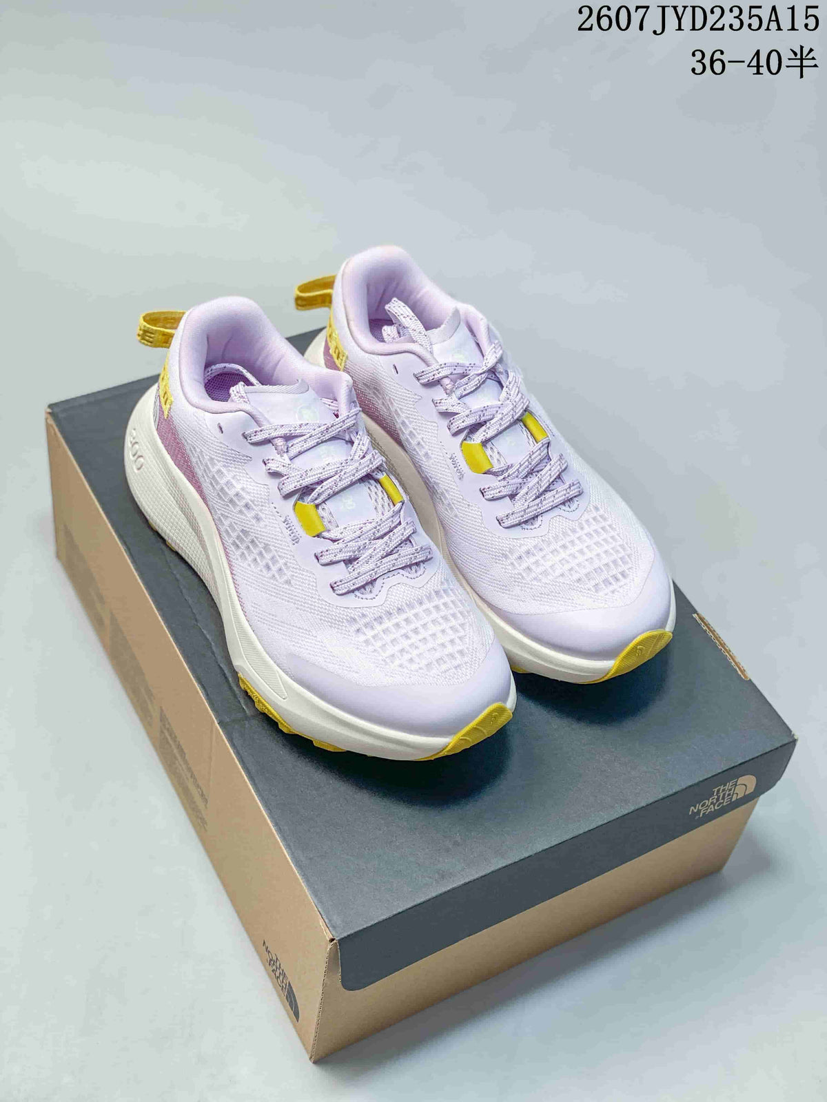 Pair of light purple, white, and yellow The North Face Altamesa 300 hiking shoes displayed on a branded shoebox.