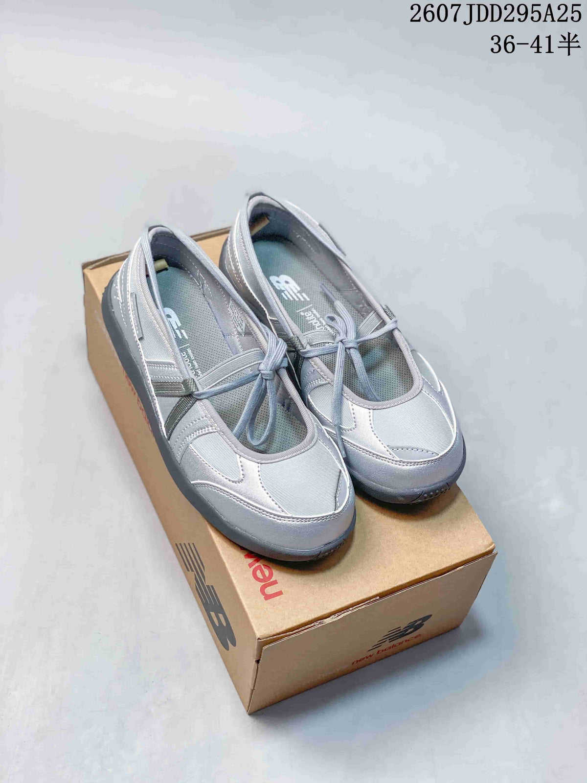 Pair of gray New Balance low-top sneakers displayed on a branded shoebox.