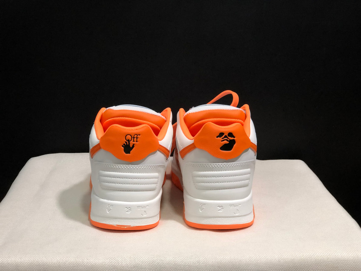 Rear view showing orange heel panels, graphic-style heel markings, and white padded heel sections.