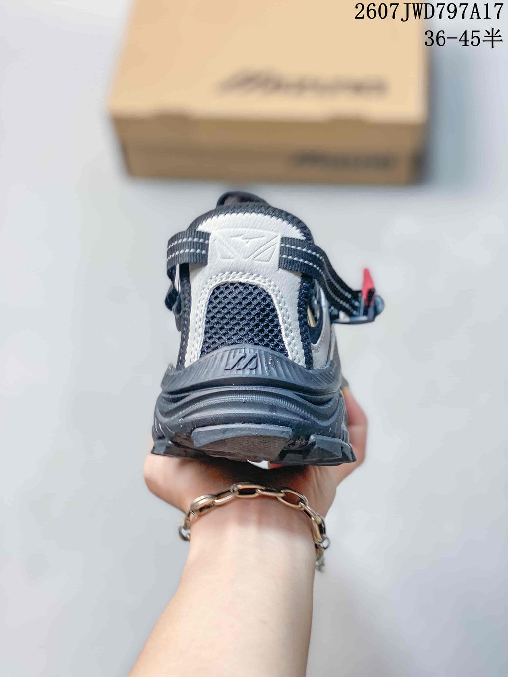 Rear view showing the padded heel, layered outsole and black-gray upper of the Mizuno sneaker.