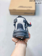 Rear view showing the padded heel, layered outsole and black-gray upper of the Mizuno sneaker.
