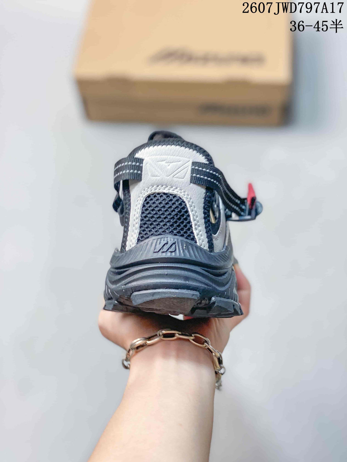 Rear view showing the padded heel, layered outsole and black-gray upper of the Mizuno sneaker.