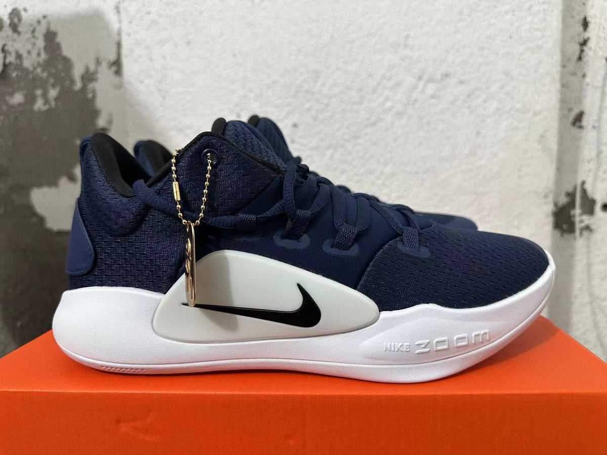 Side view of a navy blue Nike Zoom basketball shoe with white midsole