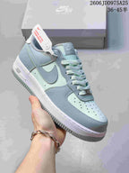 Close view of a pale blue and mint sneaker with gray Swoosh and white midsole