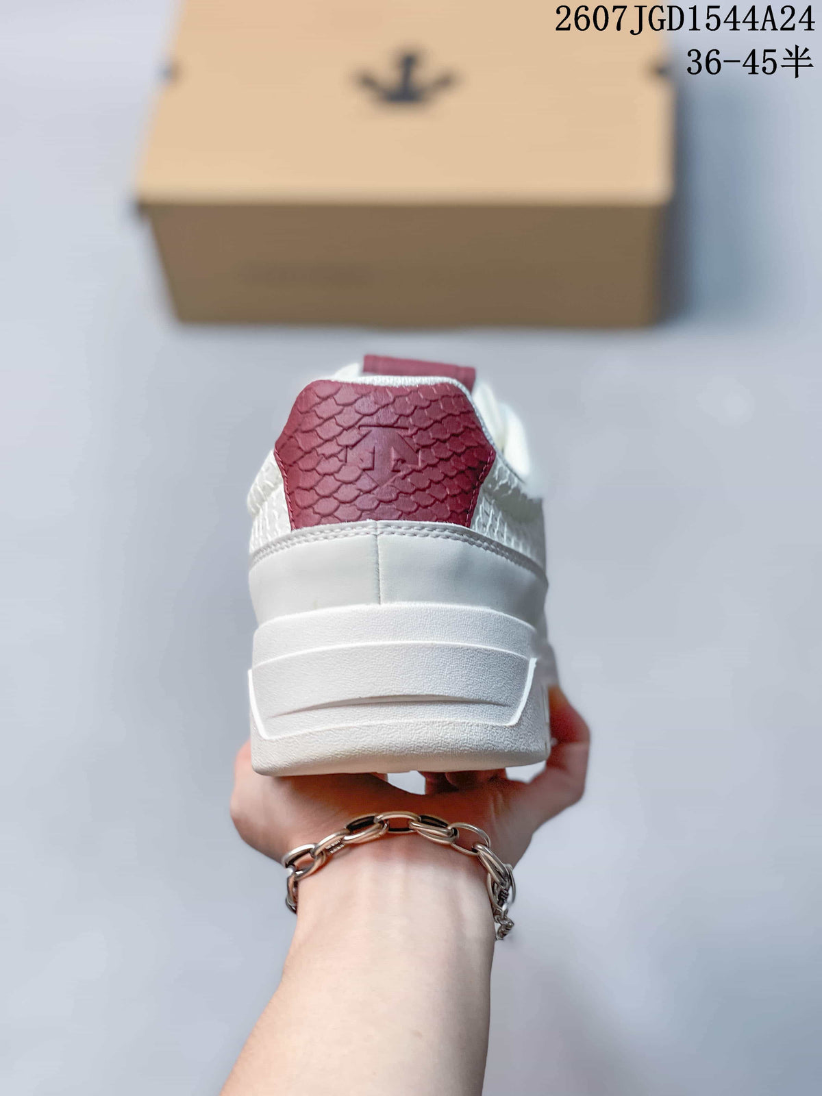 Rear view of the white sneaker showing the padded heel, layered midsole and burgundy tongue detail.
