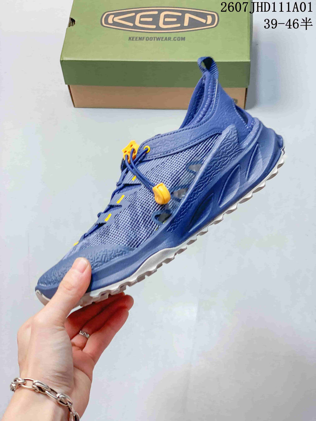 Side profile of the blue low-top hiking shoe with toggle lacing