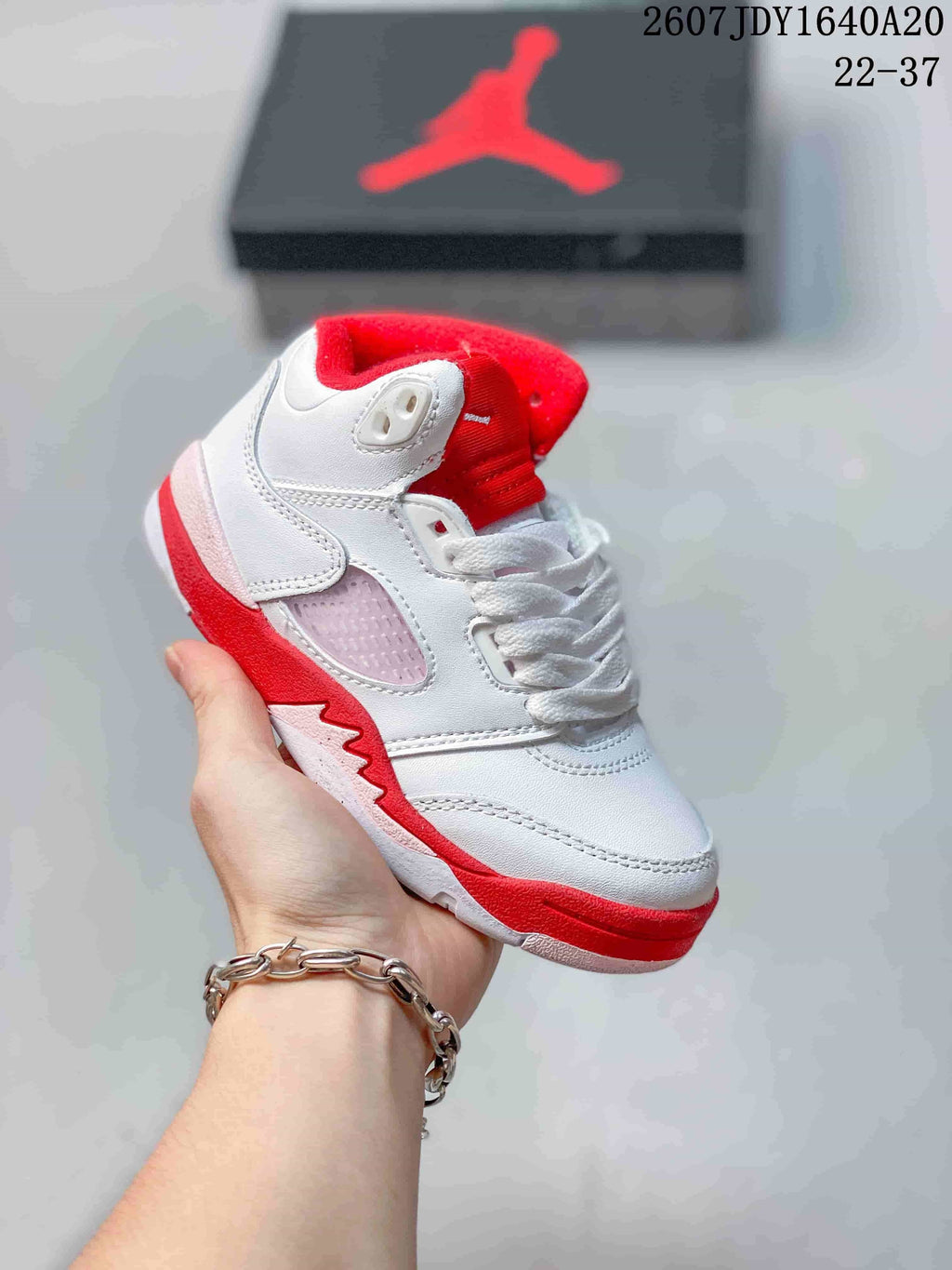 White and red kids' mid-top sneaker with red collar lining, red outsole accents, and white laces.