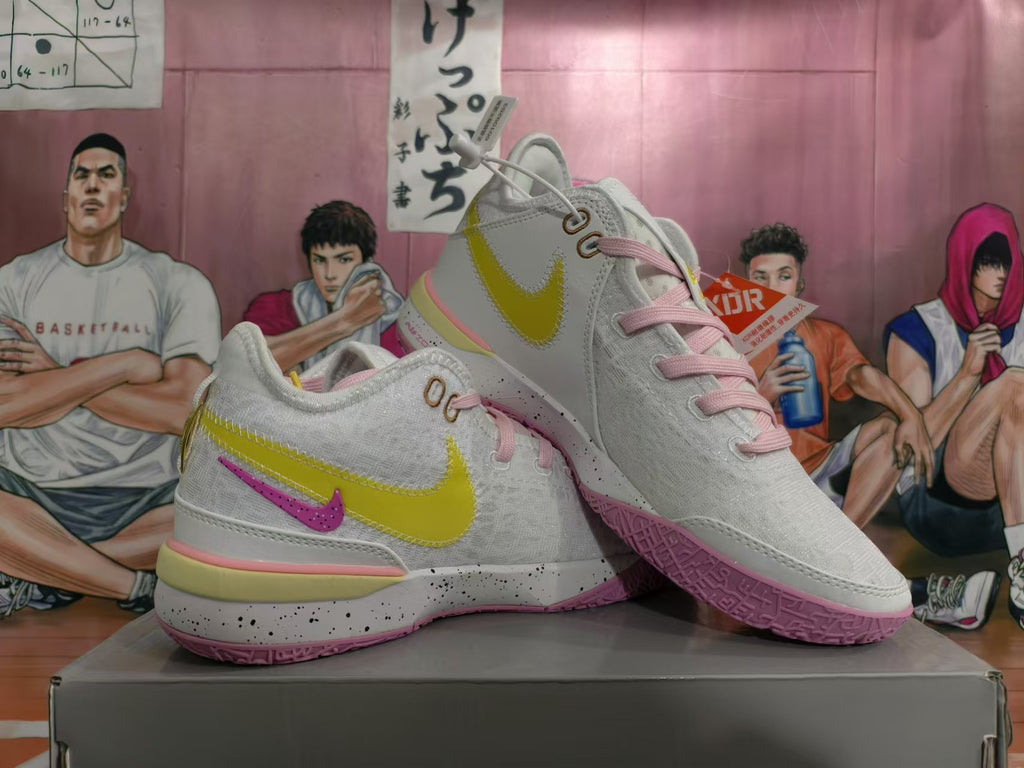 Pair of white Nike basketball sneakers with yellow, pink, and purple-pink accents