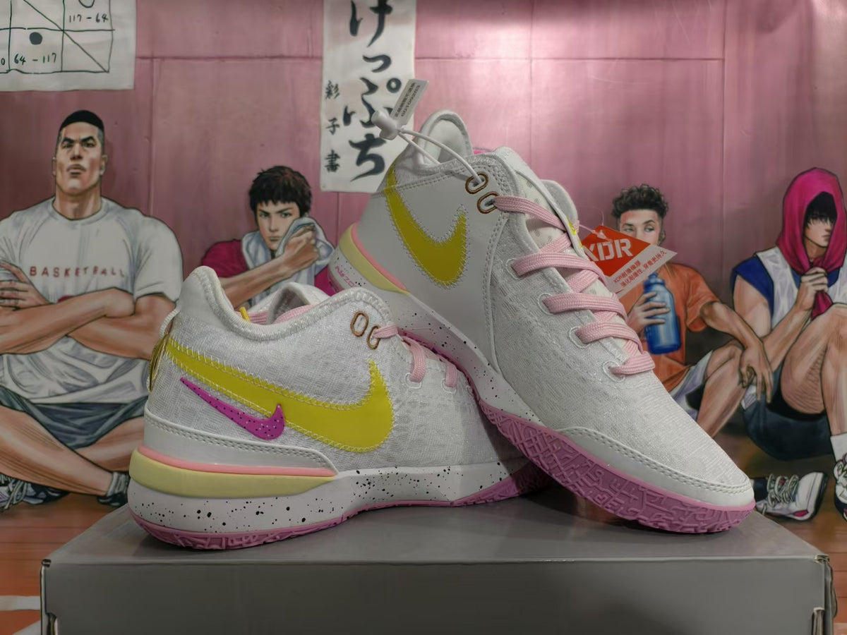 Pair of white Nike basketball sneakers with yellow, pink, and purple-pink accents