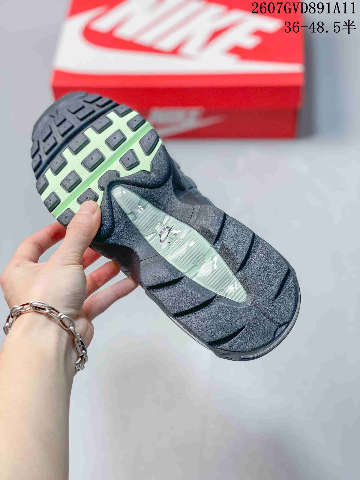 Underside view of the sneaker showing a black and green patterned outsole and a translucent midfoot section.