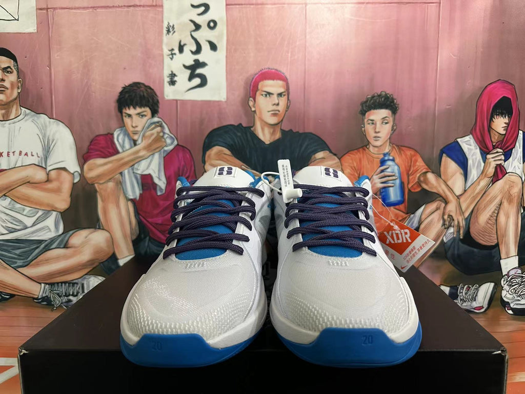 Front view of white and blue Nike basketball shoes with dark laces and blue toe accents.