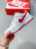 Side view of the white low-top sneaker with red Swoosh and red outsole