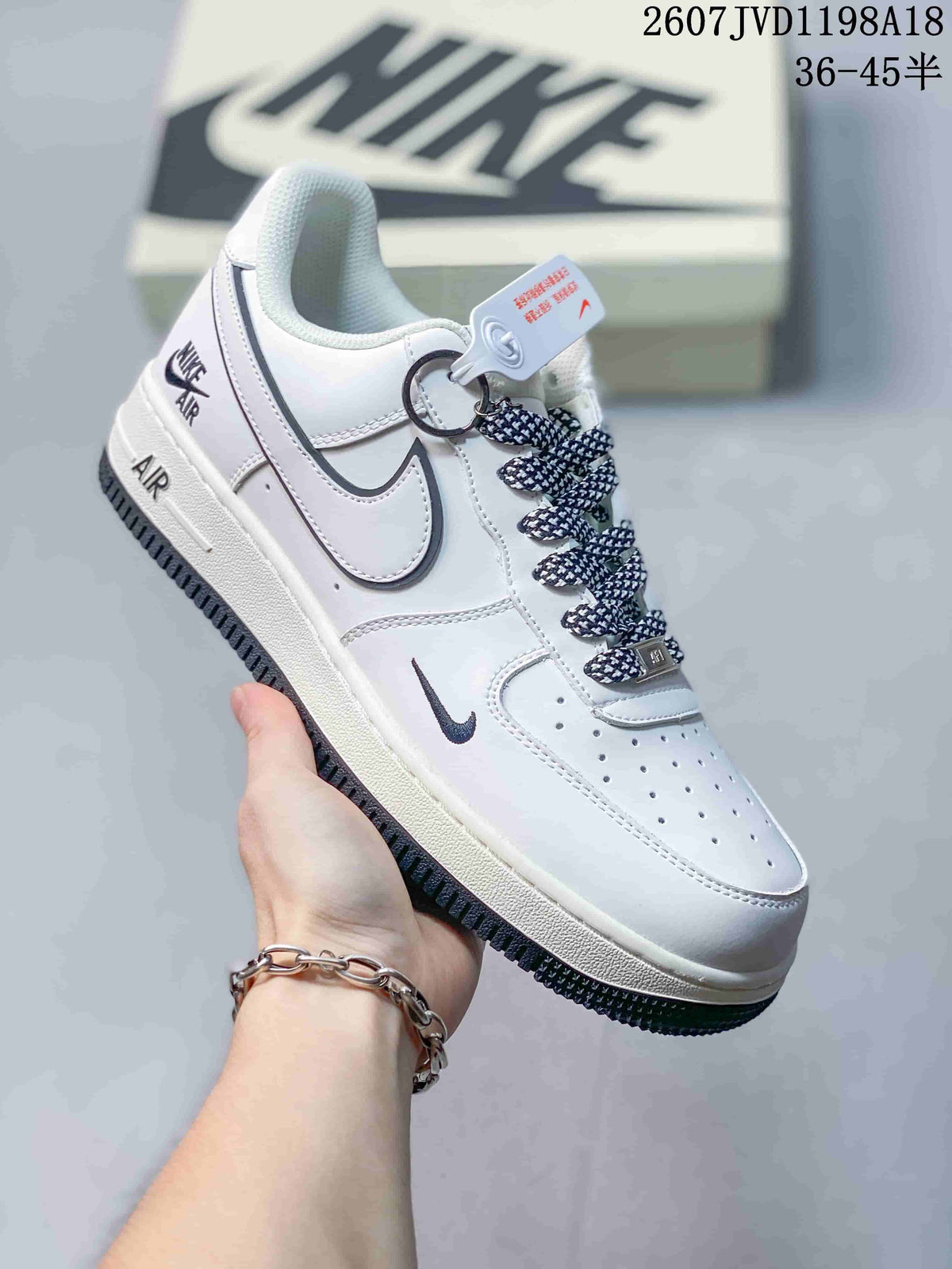 Angled side view showing the white low-top silhouette, outlined Swoosh and dark outsole.