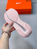 Close view of the pink textured outsole and its geometric tread pattern.