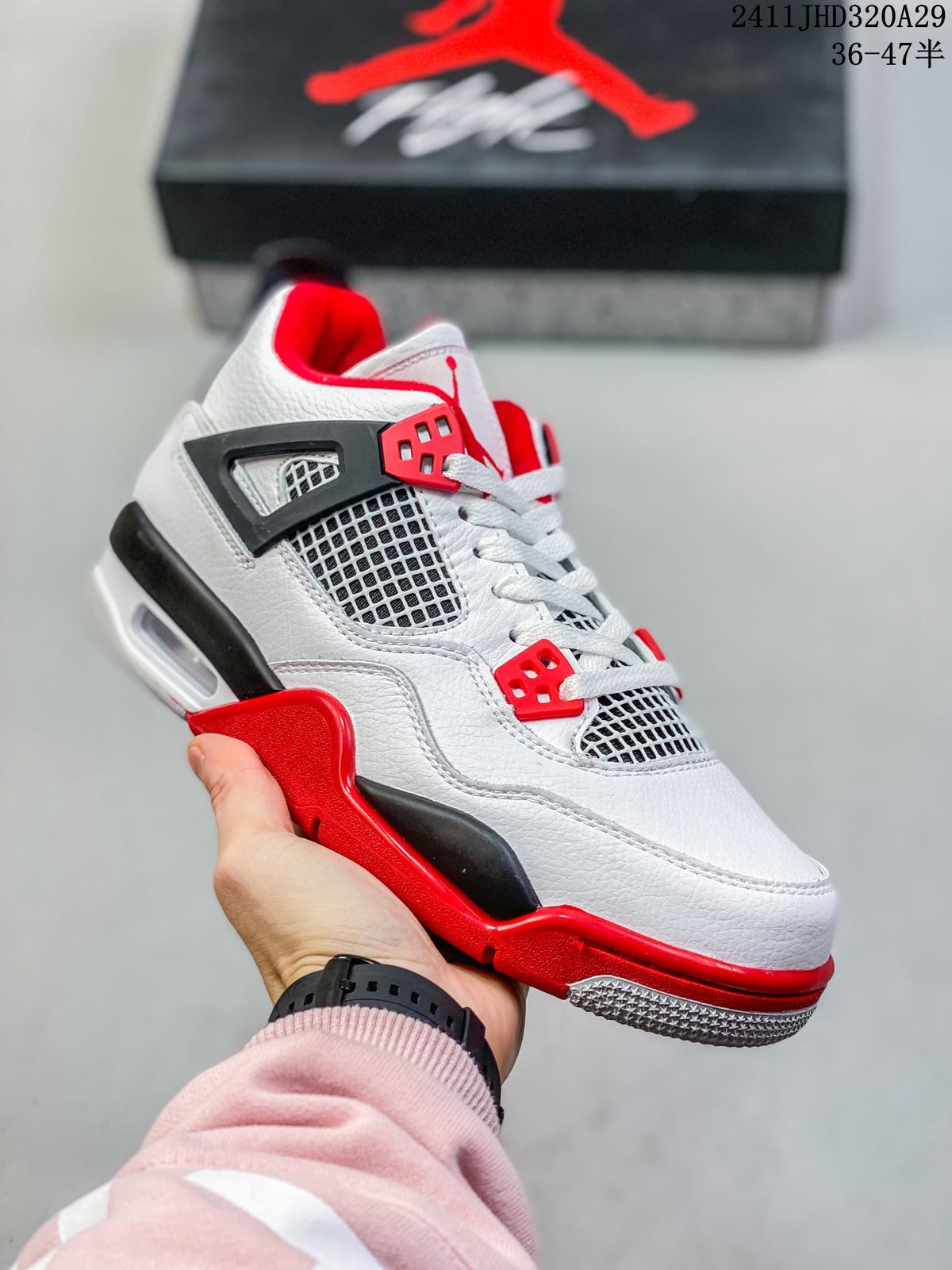 Close-up of a white high-top sneaker with red eyelets, red midsole accents, black detailing, side mesh panels, and a visible air-style heel window.