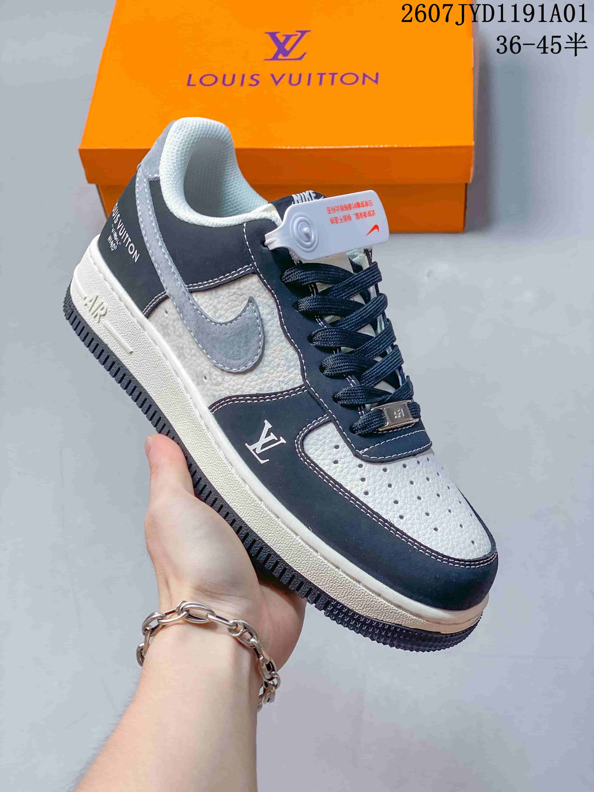 White and dark navy low-top sneaker with gray swoosh and contrasting overlays