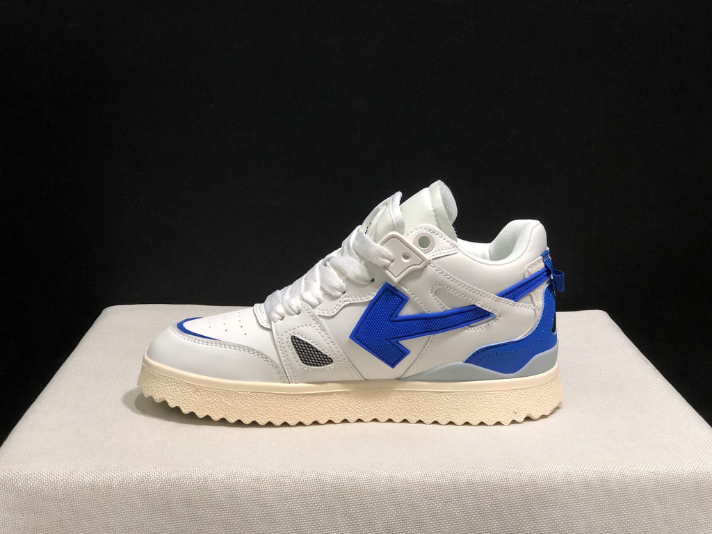 Full side profile of one white and royal blue sneaker with a large blue side arrow and cream-colored outsole.