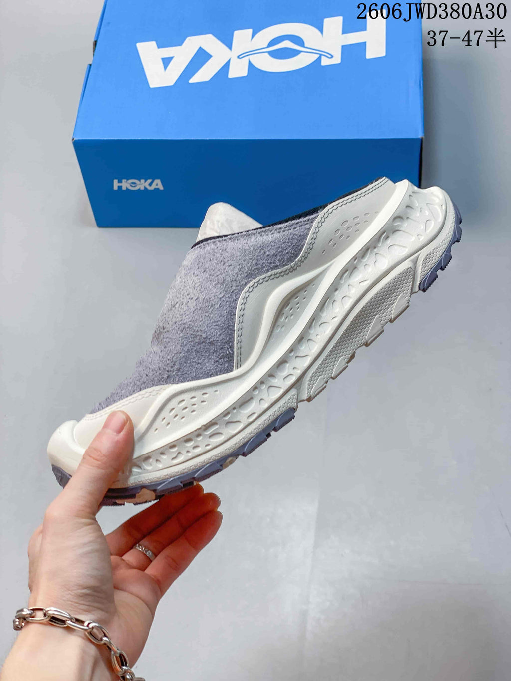 Side profile of a gray and cream HOKA Ora Primo EXT mule shoe