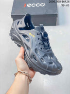 Side view of a gray perforated shoe showing its heel strap, cutouts and chunky sole.