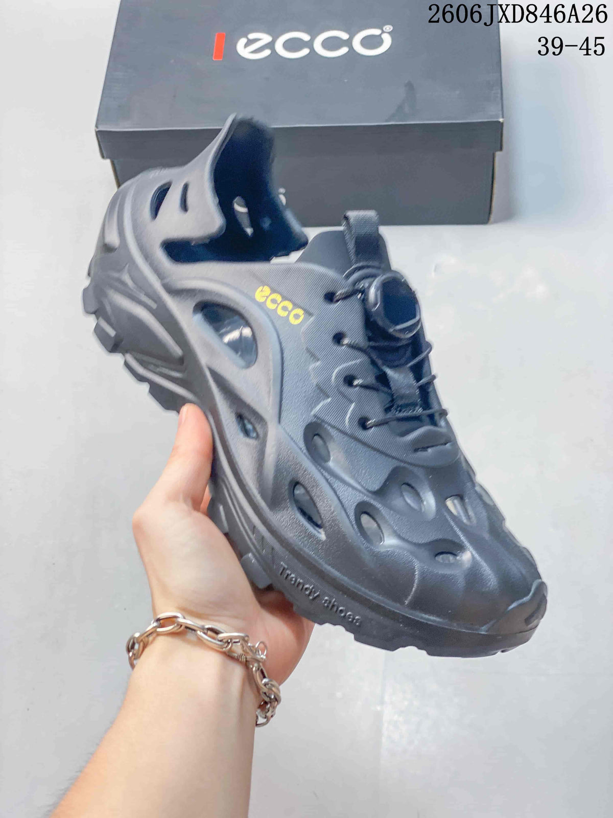 Side view of a gray perforated shoe showing its heel strap, cutouts and chunky sole.