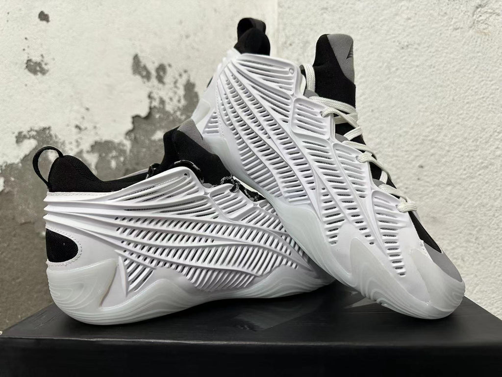 White and black sneakers displayed together, highlighting the sculpted side panels