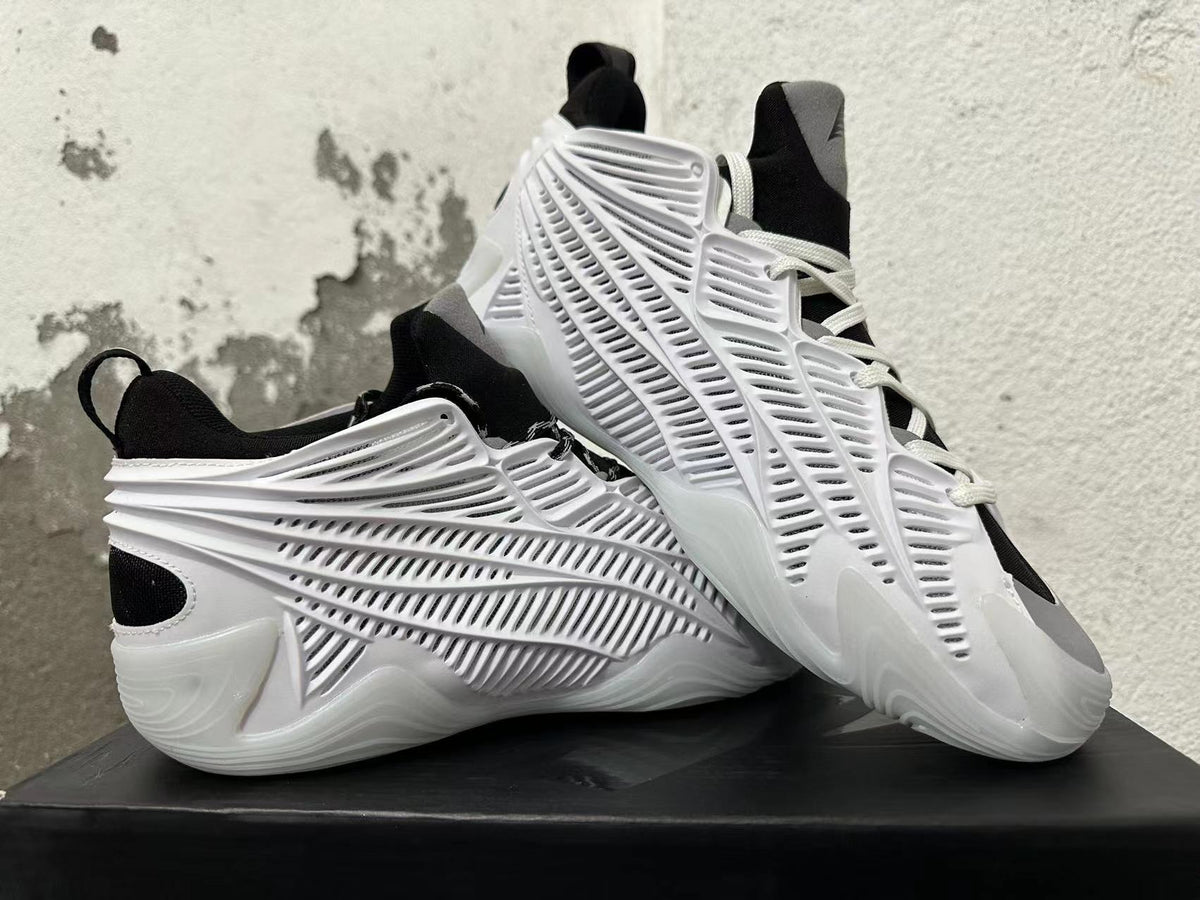 White and black sneakers displayed together, highlighting the sculpted side panels