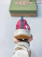 Rear view of a burgundy KEEN sandal showing the heel opening, rear pull tab, light midsole, and outsole.