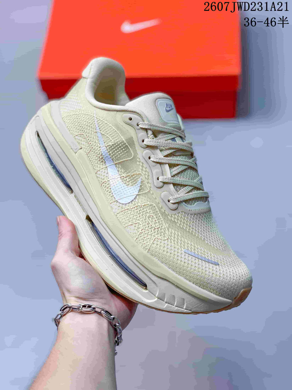 Angled side view showing the cream upper, reflective-looking accent details, Nike Swoosh, and blue midsole units.