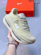 Angled side view showing the cream upper, reflective-looking accent details, Nike Swoosh, and blue midsole units.