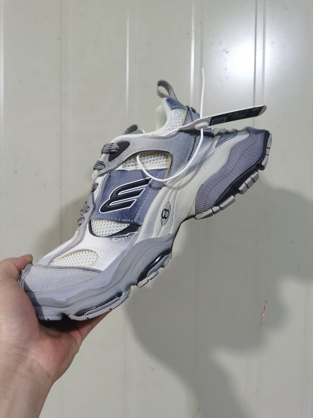 Front three-quarter view highlighting the mesh toe and tongue, layered upper, lace fastening, and chunky outsole.