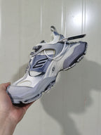 Front three-quarter view highlighting the mesh toe and tongue, layered upper, lace fastening, and chunky outsole.