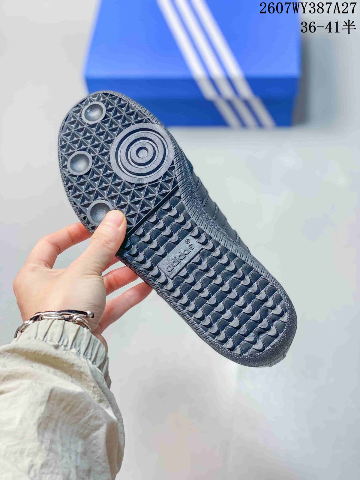 Close-up of the textured black rubber outsole with circular tread details and adidas branding.
