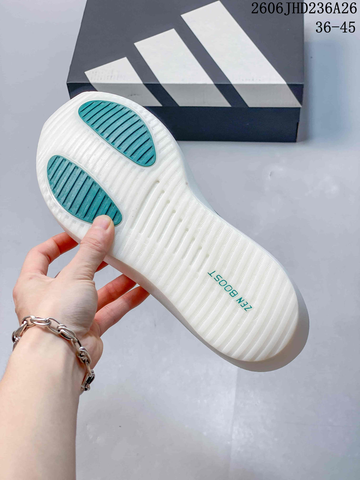 Underside of a white ZenBoost shoe showing two green traction areas and a ridged sole.