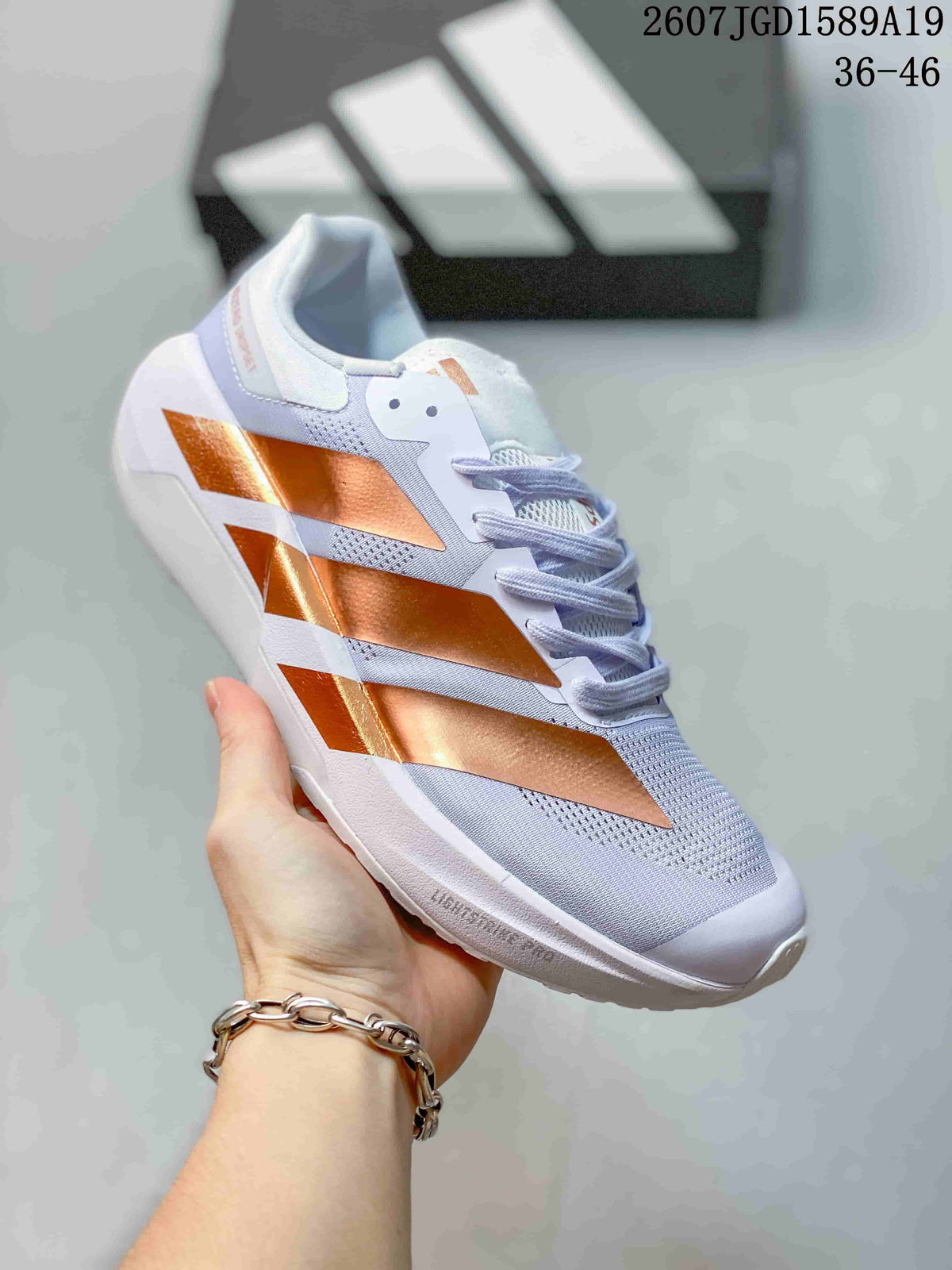 Angled side view of the white sneaker highlighting the metallic copper geometric panels and white sole; image text indicates 36–46.
