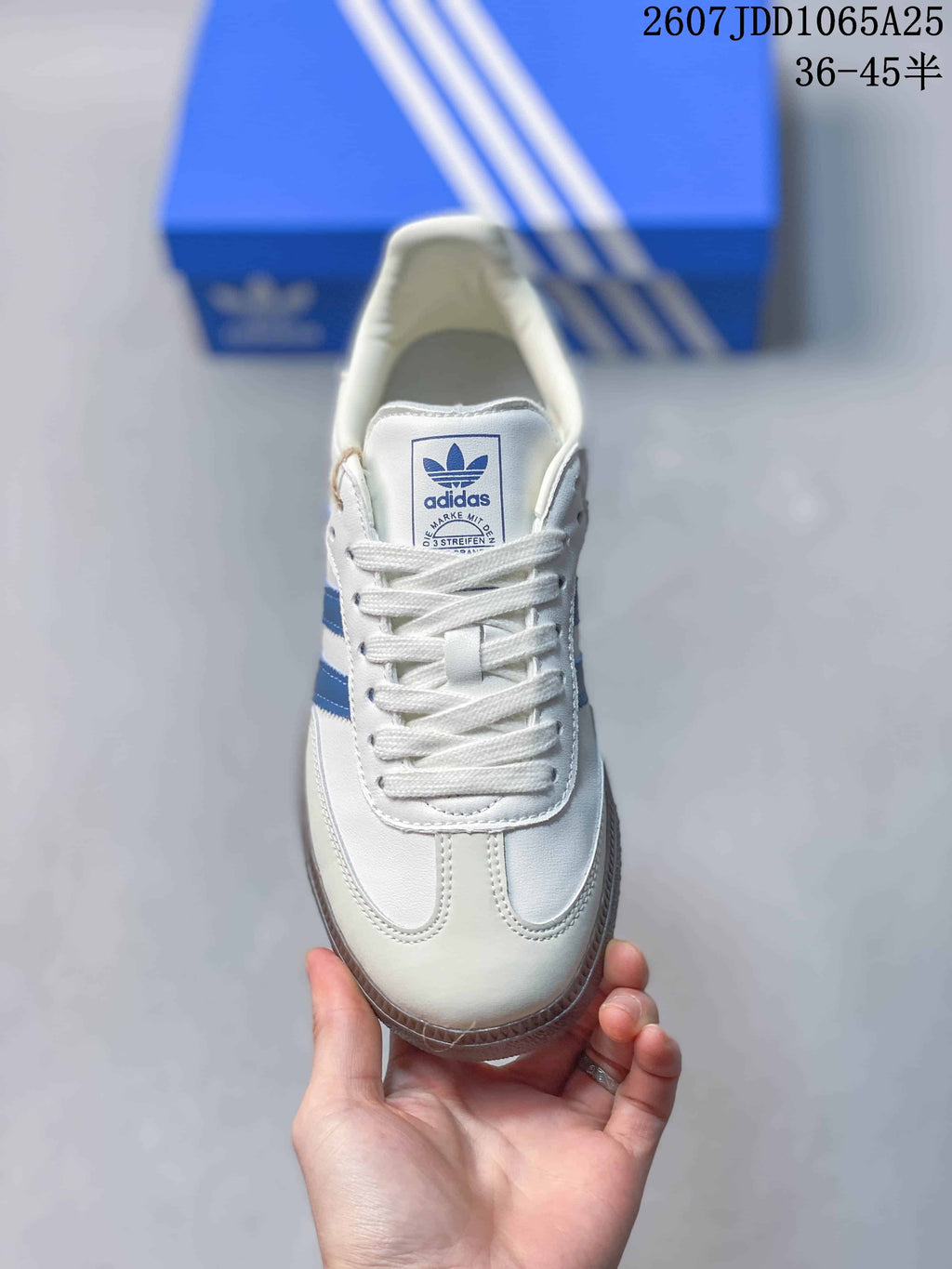 Top view showing the white lace-up upper, tongue branding, and blue side detailing.