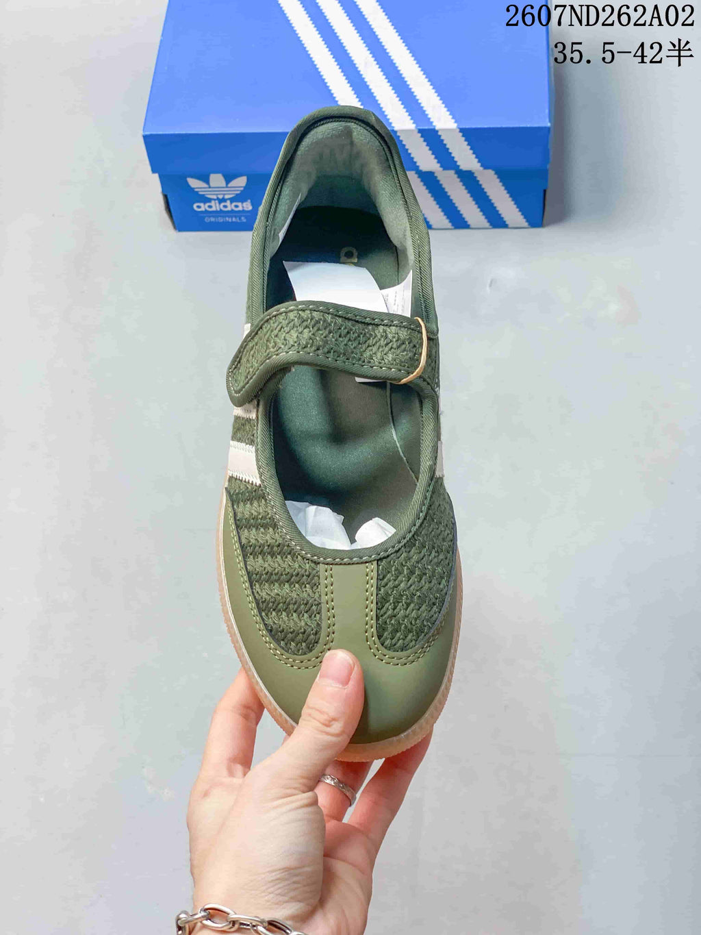 Top view showing the sneaker's hook-and-loop strap and textured olive-green upper