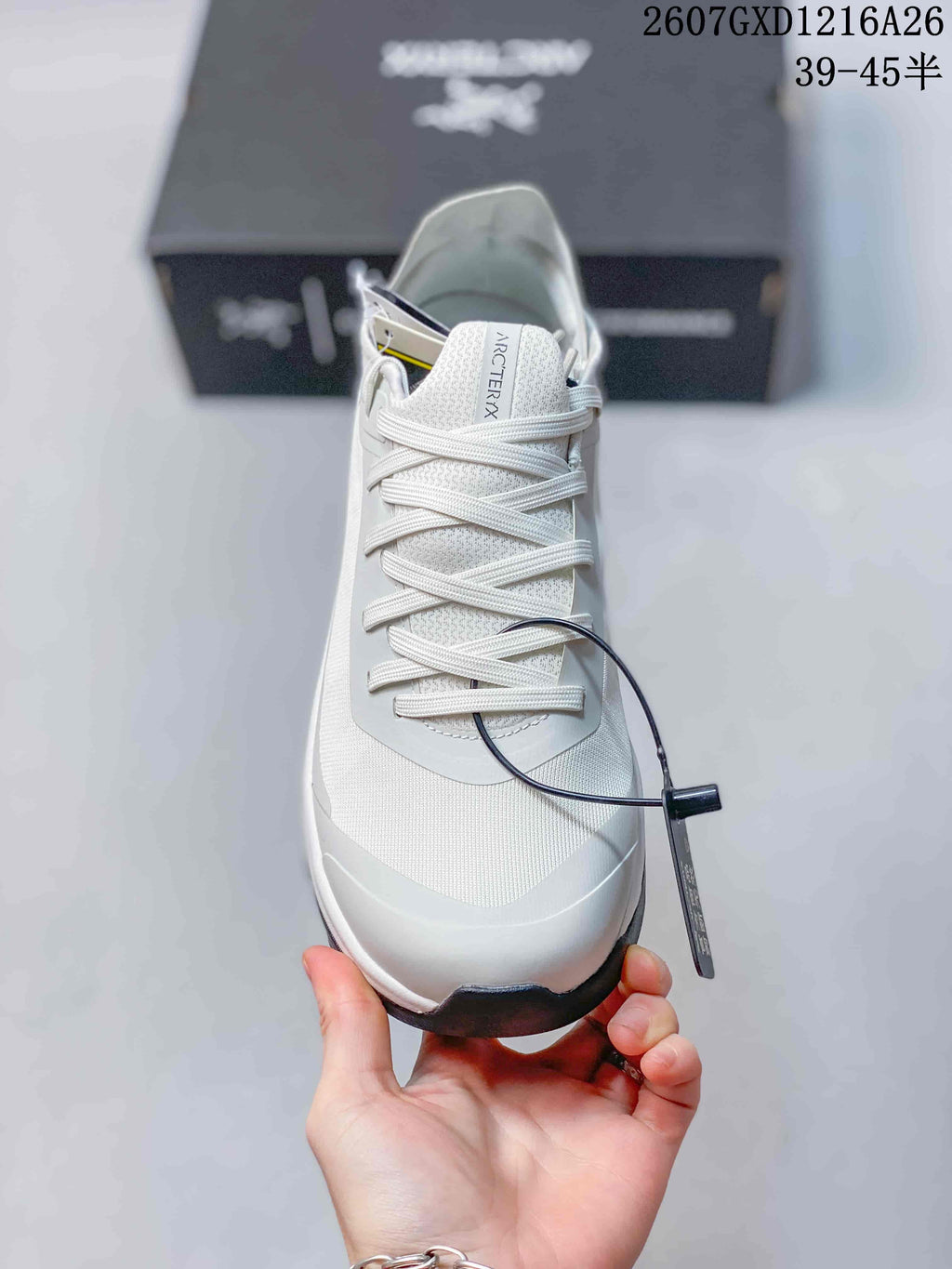 Top view showing the white laces, textured tongue, toe panel and attached product tag.