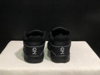 Rear view of the black sneakers showing padded collars, heel panels and white embroidered graphics.