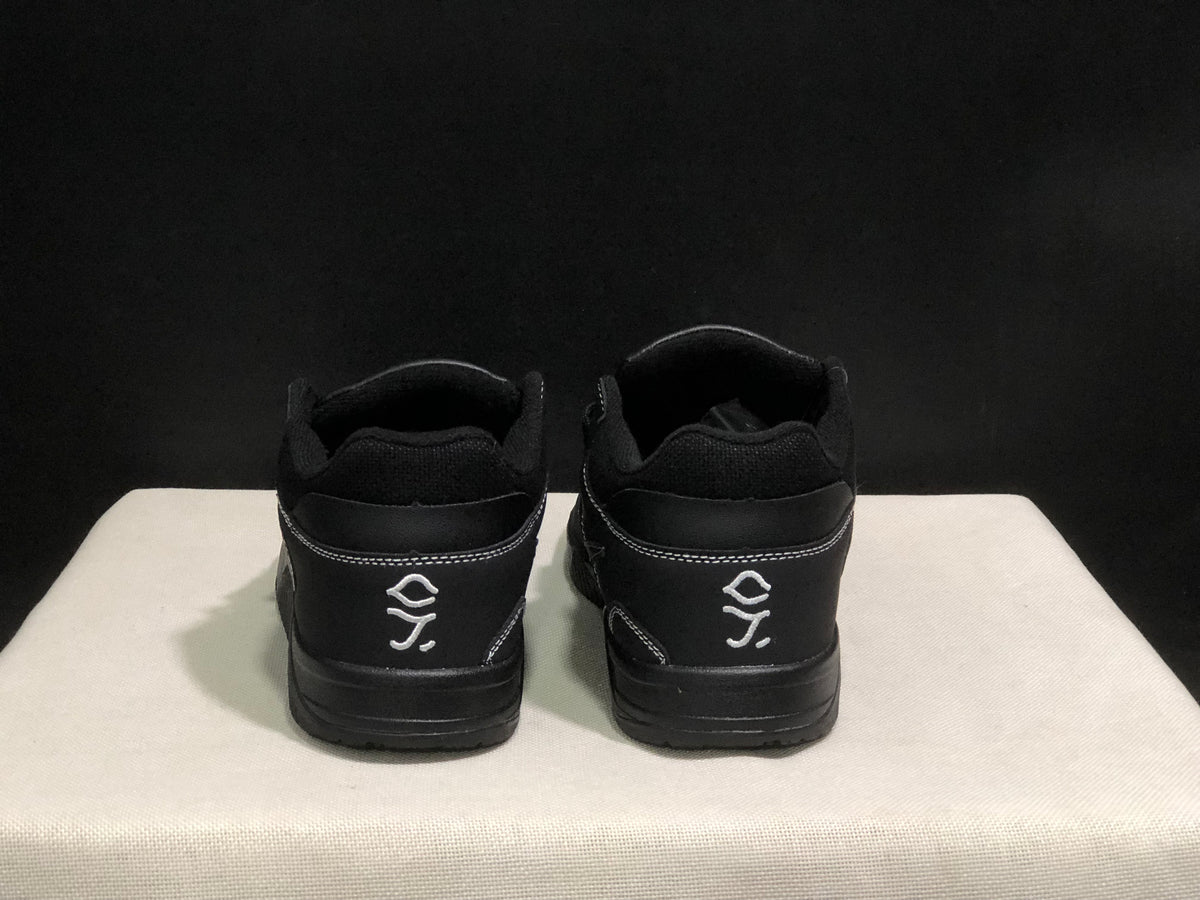 Rear view of the black sneakers showing padded collars, heel panels and white embroidered graphics.