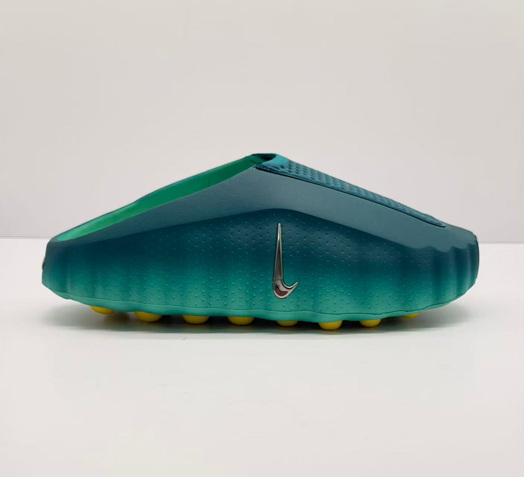 Side view of a green Nike slide sandal with a textured upper and yellow outsole pods.